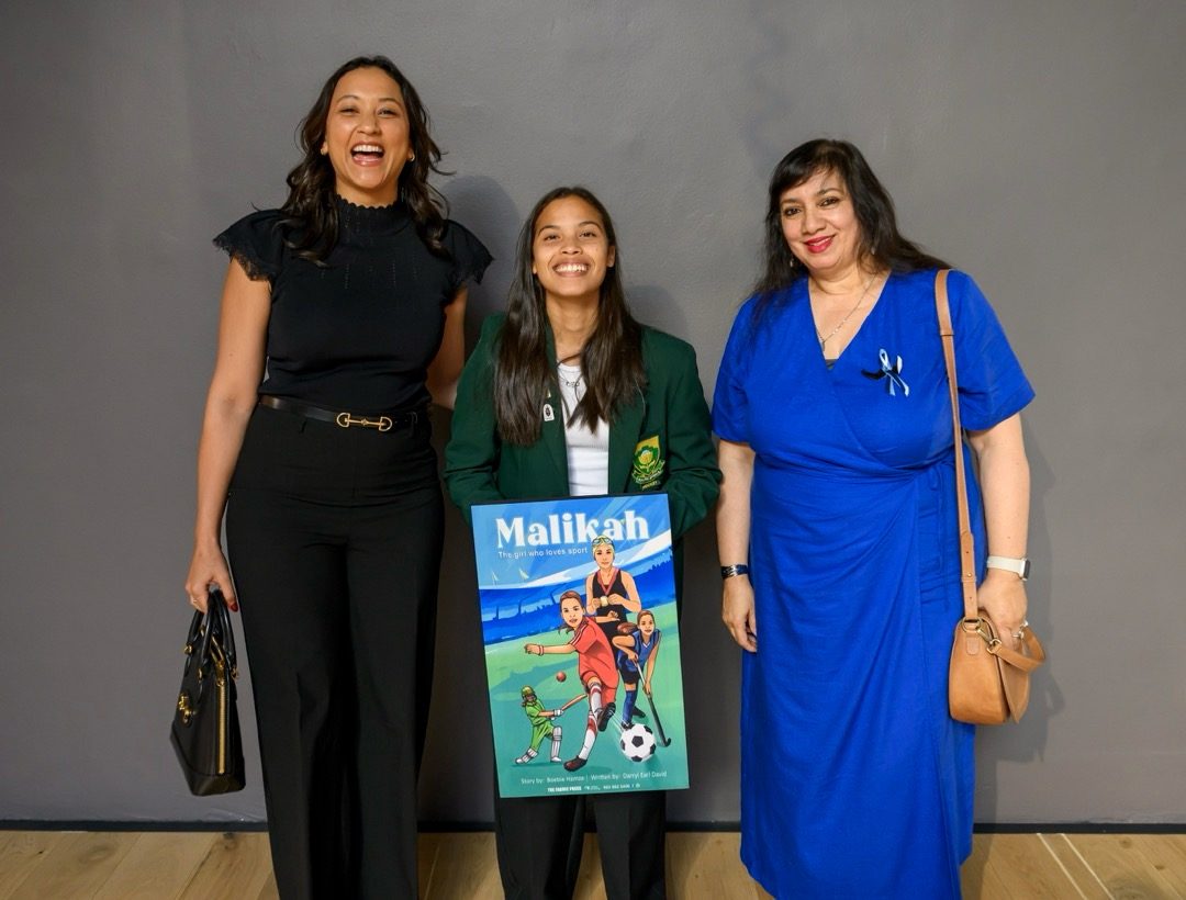Tricia Survé with Malikah Hamza and a guest holding the Malikah book cover