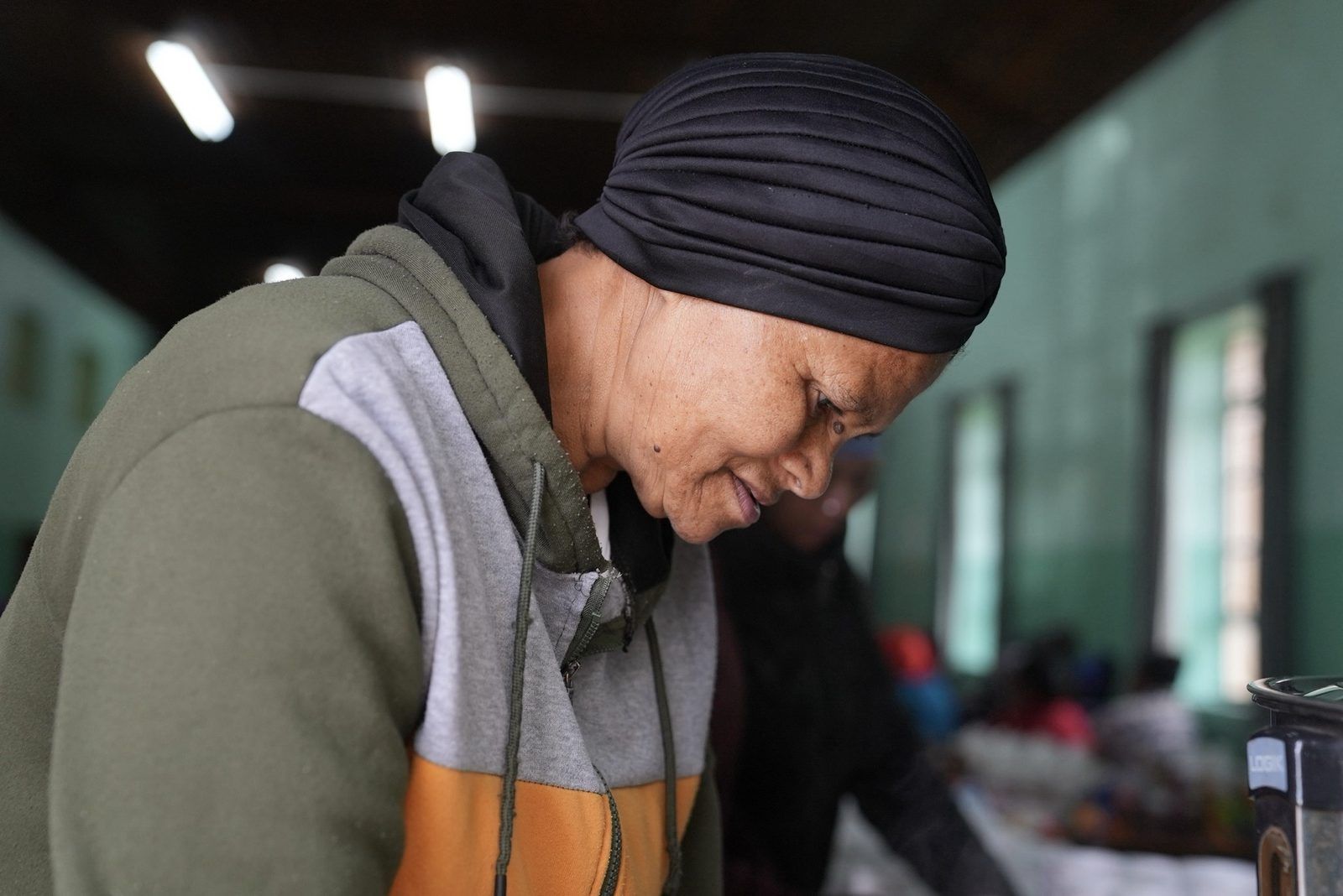 A woman preparing food at a community feeding day